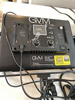 Rear view of one GVM LED panel showing control panel with LCD, dual NP-F battery plates, control knobs and power switch