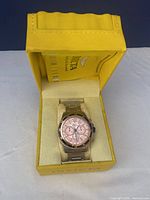 Invicta men's chronograph wristwatch in yellow presentation box, showing pink dial and stainless steel band.