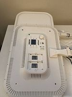 Back side of one Neewer RGB168 LED photo light showing battery slots, LCD screen, control buttons, and power switch.