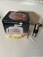 Photo of Donaire manual ice cream freezer box with ice cream cones pictured and hand crank visible on top.