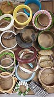 Top-down photo of various bangle bracelets in different colors and materials in a tray.