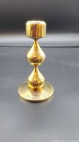 Front view of gold plated candlestick showing shape and design