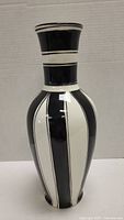 Front view of the Mikasa black and white striped ceramic vase showing its shape and vertical stripe pattern.
