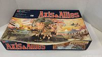 Closed original Axis & Allies game box showing cover art with World War II military officers, tanks, planes, and ships.
