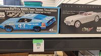 Box of Richard Petty's 1969 Ford Torino Talladega model car and 1953 Corvette 50th Anniversary model car shown together.
