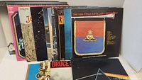 Photo showing approximately 9 album covers standing upright, visible artists include Frank Zappa, Pink Floyd, Supertramp, and Bruce Springsteen.