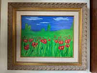 Photo of the framed acrylic painting featuring red flowers and green grass with a blue sky background.