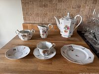 Bavarian coffee/tea pot, creamer, sugar bowl, one cup, and two plates with floral and gold decoration