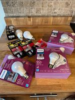 Light bulbs from Philips and other brands, packaged and loose on a wooden surface