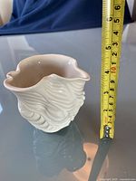 Front view of pottery vase showing textured swirl design and measuring tape indicating approx. 5 inches height.