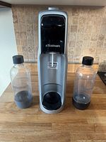SodaStream soda maker with two plastic bottles and carbonation cartridge