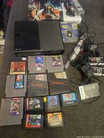 Photo of the Xbox console, NES cartridges, controllers, and Game Boy cartridge and case spread out on a couch.