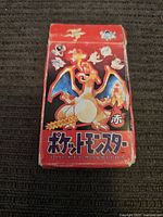 Front view of red Charizard box with signs of wear and original Pokémon characters.