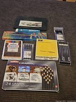 Full overview of all the artist supplies laid out including various pencils, erasers and art tools