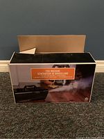 Box of fog machine showing product image and fog output indication on front panel.