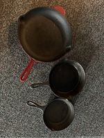 Top view of all three frying pans showing size and color differences.