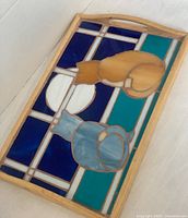 Wooden framed stained glass tray featuring two cats looking at a full moon with blue, teal, white, and amber colored glass pieces
