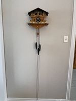 Full view of the wall-mounted cuckoo clock hanging on wall