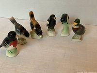 Set of six vintage TenderLeaf Tea Canadian Collection porcelain birds arranged on table, showing front and side views.