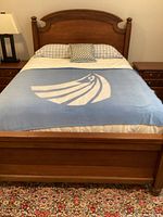 Front view of assembled queen bed with bedding