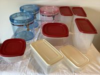 Rubbermaid plastic containers with red lids, white plastic containers with beige lids