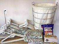 Laundry basket, towels, Epsom salts, and plastic hangers arranged for overview