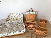 Multiple Longaberger baskets arranged showing fabric liners and clear plastic organizer insert.