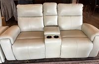 Front view of the off-white reclining love seat with seats upright