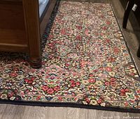 Partial under-bed view showing floral motif and navy border