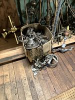Lantern tops and parts in box with chains and other metal pieces