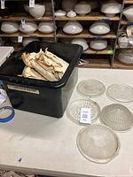 Box with approx 12 Holophane glass lenses and five lenses laid out showing various circular and radial textured patterns.