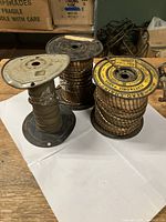 Photo of three spools of antique square bead chain on metal reels, showing general size and quantity