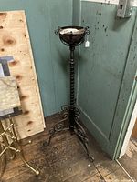 Full view of the Victorian wrought iron piano lamp floor lamp showing the tripod base with ornate scrollwork and the top font holder.