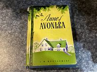 Front cover showing dust jacket with illustration of house and title 'Anne of Avonlea' by L.M. Montgomery