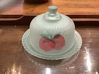 Glass cheese or butter dish with frosted glass dome lid featuring apple graphic, and clear glass plate base with scalloped edge and Arcoroc France embossed mark.