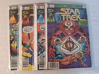 Four 1981 Star Trek comics showing partial front covers with vibrant vintage comic art and price of 50 cents, bagged and boarded.