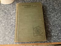 Photo of the front cover of the book 'Handbook of Nature-Study' showing green cloth and spider web design.