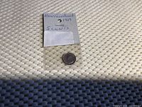 Photo of the 1929 Newfoundland 5 cents silver coin inside a protective plastic holder with label.