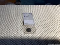 Photo showing the 1943 Newfoundland 5 cents coin in a protective sleeve with label.