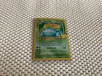 Front view of early edition Venusaur Pokémon trading card showing the artwork, 100 HP, and Solarbeam attack details.