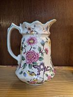 Front view of the vintage Old Foley floral jug showing intricate pink and purple flowers with bird motifs.