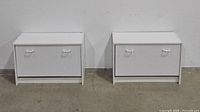 Pair of white shoe cabinets side by side showing front view with closed doors.