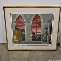 Full-frontal view of the framed print resting against a wall