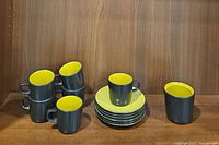 Full set with 6 cups stacked on saucers and 1 sugar bowl next to them, showing overall lot contents.