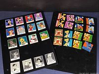 Two boards of Disney square trading pins showing colorful and black & white signed character designs.