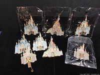 Eight castle pins on black background, three sealed at top, five loose below