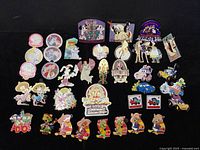 Overview of the entire lot of 35 colorful Disney trading pins displayed on black background.