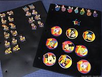 Display of 38 Disney trading pins including large number character pins and smaller multilingual number pins.