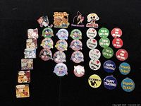 Full view of the 36 Disney pins laid out on a black background showing classic characters, text pins, and trading-themed pins.
