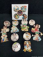 Full view of 19 Disney pirate trading pins on black background showing variety of designs